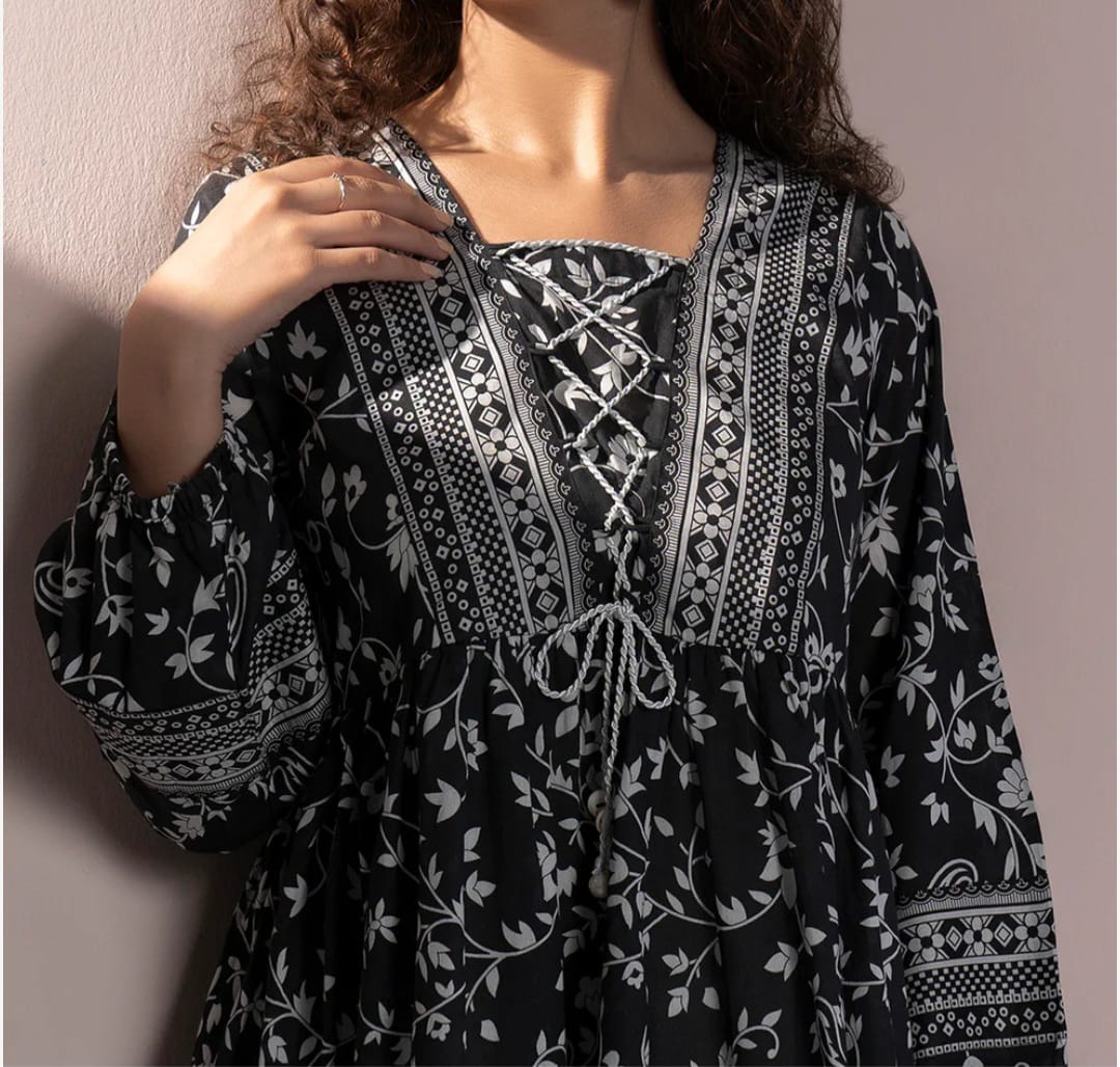 Black and white patterned dress with intricate designs on a plain background
